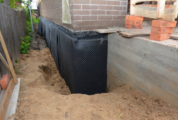SJ Waterproofing Pros technician performing targeted Wet Basement Repair assessment in Clinton, MI